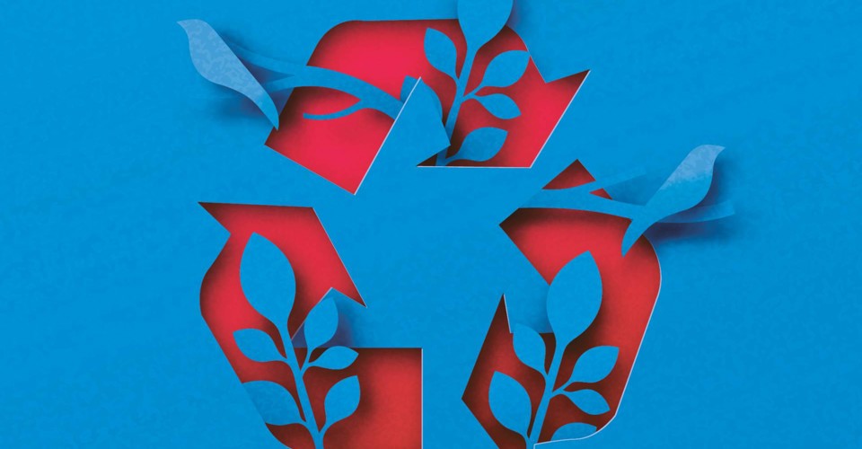 Colorful paper recycling symbol with green leaves, representing sustainability and environmental awareness.