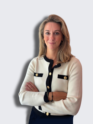 Karin in a white and black cardigan with arms crossed, against a neutral background.