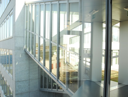 Modern office buildings with large glass facades reflecting the surrounding environment.