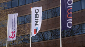 Flags of Lot, NIBC, and Olimia are fluttering in front of a modern building wall.