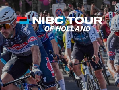 A group of cyclists in action during the NIBC Tour of Holland, with spectators along the roadside.