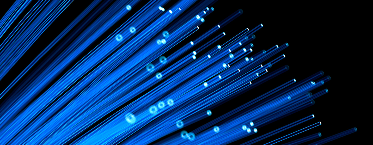 Blue light rays and fibers emanate against a black background, symbolizing data connectivity and modern technology.